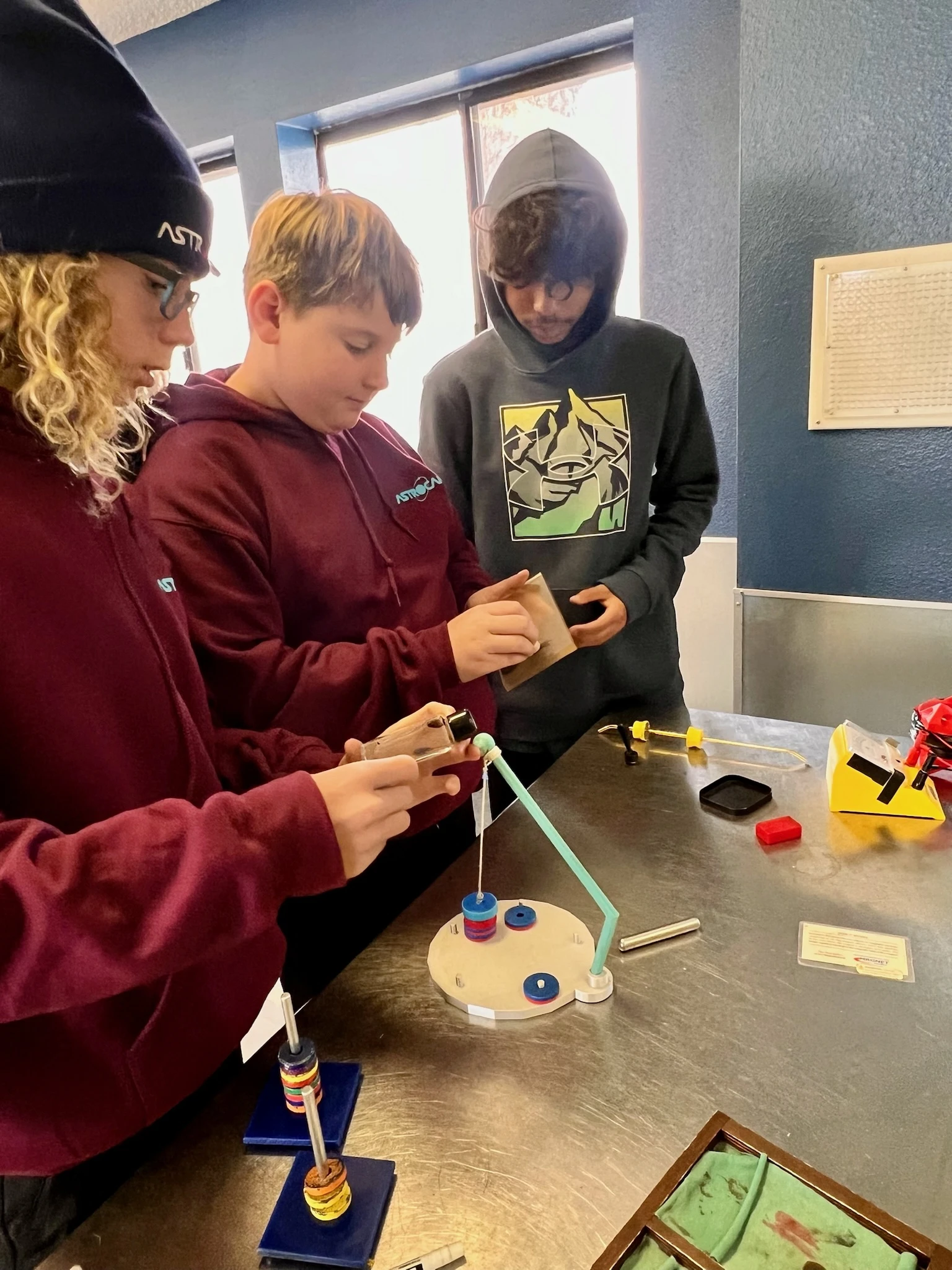 Page Academy students working on a magnet experiment at a lab table during the AstroCamp field study