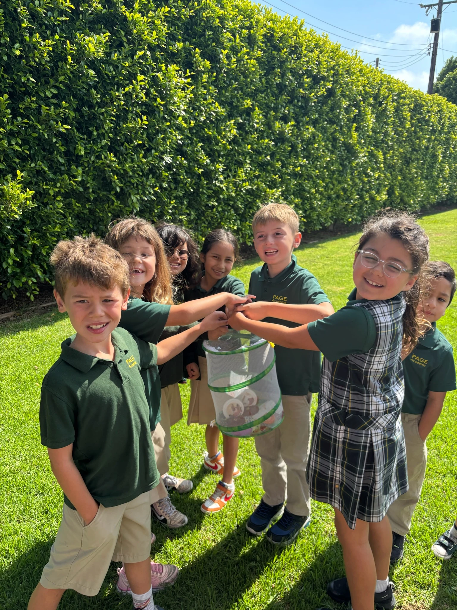 Page Academy students stacking hands on the field