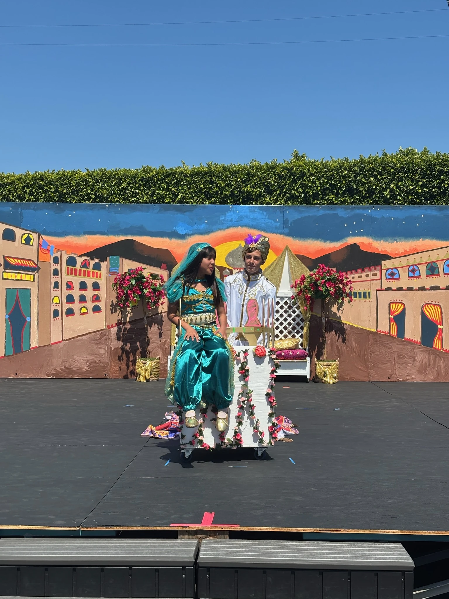 Page Academy students performing on stage in front of a painted set